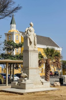 In front statue of monument to Dutch Queen Wilhelmina, in the background Cathedral of the Queen of