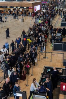 Interior of Willy Brandt International airport, people standing in line