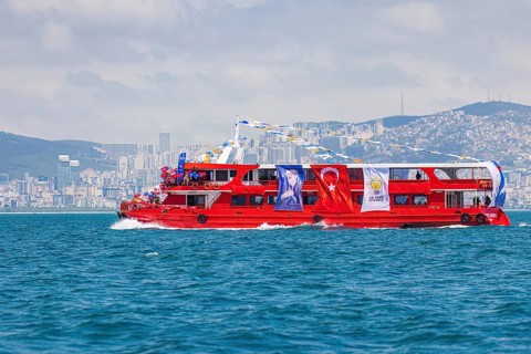 Supporters of the ruling AK party waving turkish flags on a red boat before presidential elections