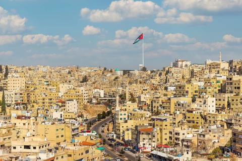 Jordan flag in Amman, panorama view of cloudy sky