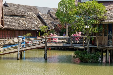 Wooden bridge and traditional houses around a quiet canal at the floating market, Pattaya,