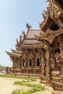 Detailed view of an ornate wooden temple, light and shadow effects on the structure, Pattaya,
