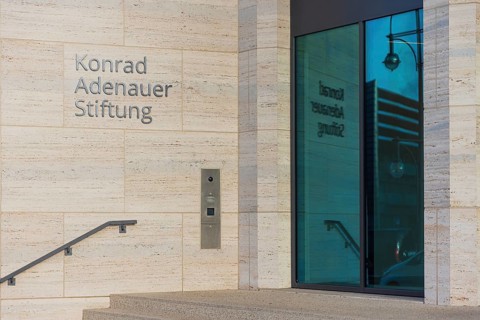 The lettering of the Konrad Adenauer Foundation reflecting in the window