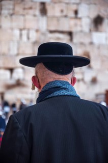 Religious orthodox jew from behind at the Western Wall in the old city of Jerusalem Israel