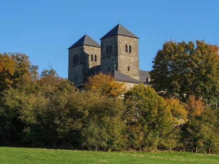 Castle with two towers, embedded in autumnal forest and illuminated by sunlight, nottuln,