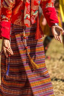 Dancer in traditional colorful clothing at a tshechu festival in Bhutan