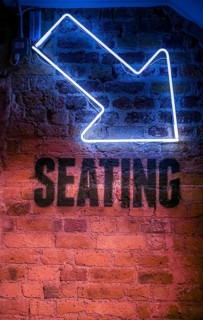 Seating sign with arrow pointing down