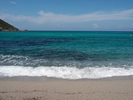 Waves crashing on a sandy beach, with a sweeping view of the open sea and the horizon, ajaccio,