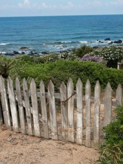 Old wooden gate with a view of the coastal landscape and the sea, ajaccio, corsica, france