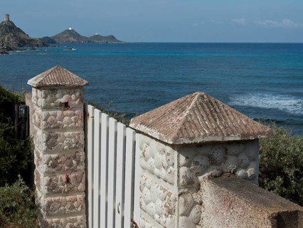 White Tor tor with stone columns overlooking the sea with hills in the background, ajaccio,