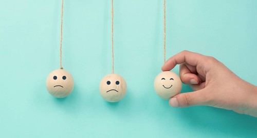 Happy smiling face spread happiness to sad faces, newton cradle concept, mental health and