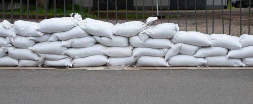 Sandbags for flood defense, river Moselle Trier in Rhineland Palatinate, flooded trees and paths,