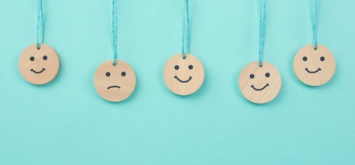 Happy smiling face spread happiness to sad faces, newton cradle concept, mental health and