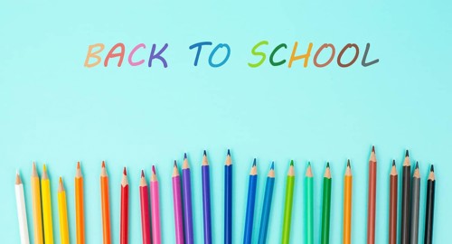 Color pencils collection in a row, back to school, drawing supplies, blue background with copy