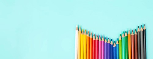 Color pencils collection in a row, back to school, drawing supplies, blue background with copy