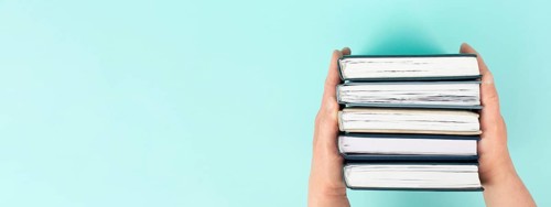 Hands holding pile of books, reading and learning new skill, knowledge is power, education concept,