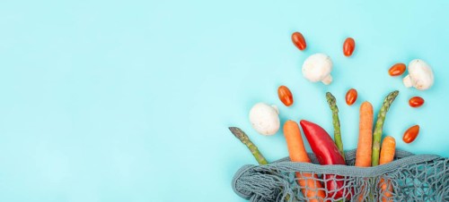 Asparagus sprout, mushrooms, carrots and tomatoes, zero waste, mesh bag with vegetables, shopping