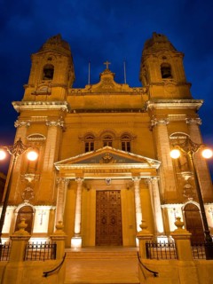 Historic church, warmly lit at night, marsaxlokk, mediterranean sea, malta