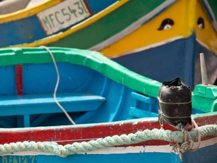 Detailed view of colourful boats docked at the harbour, marsaxlokk, mediterranean sea, malta