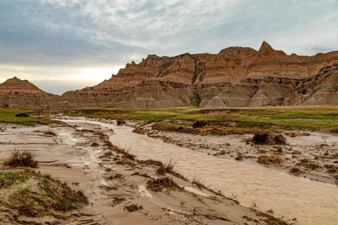 Badlands National Park, South Dakota, A stream runs through the normally dry landscape after a