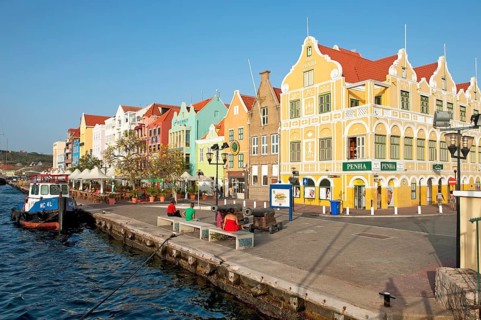 View of harbour promenade of Willemstad with landmark Handelskade houses in colonial style in Dutch