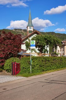 Church of St. Wendelin and bus stop in the centre of the historic district of Geschwend, Todtnau,