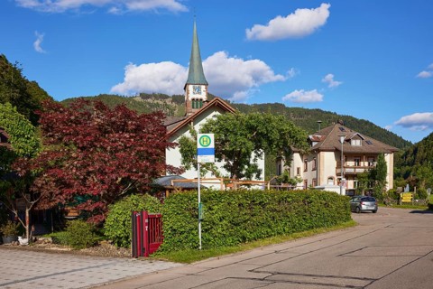 Church of St. Wendelin and bus stop in the centre of the historic district of Geschwend, Todtnau,