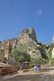 Church tower of Notre-Dame-de-l'Assomption and view to the rock, cliffs, mountains, summit,