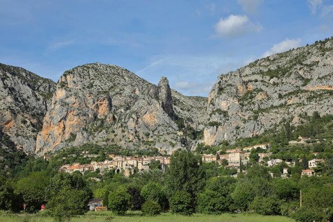 View of mountain village Moustiers-Sainte-Marie with rocks, mountains, cliffs, Provençal Alps,