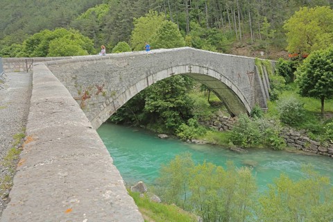 Stone arch bridge Pont du Roc built 15th century over the river Verdon, tourists, Castellane,