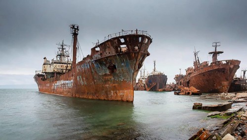 Abandoned, rusty shipwrecks in the water under a cloudy sky, a gloomy and desolate scene, symbol