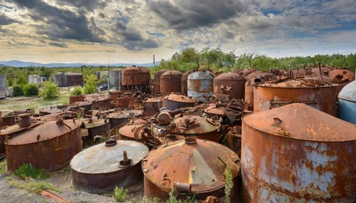 Rusty tanks in a junkyard under a partly cloudy sky, symbol photo, AI generated, AI generated