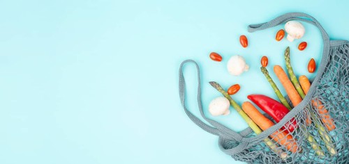 Mesh bag with vegetables, shopping grocery, healthy food ingredients, asparagus sprout, mushrooms,