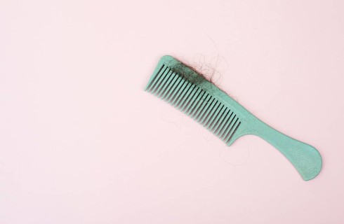 Comb with hair loss, health problem, issue of aging, alopecia areata by stress or infection,