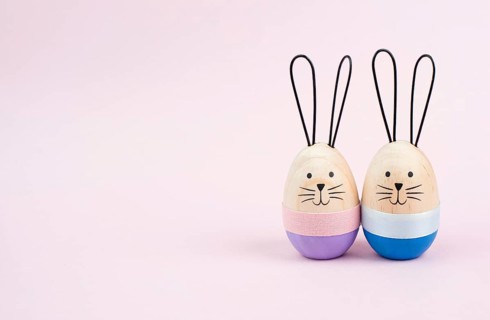 Easter bunny or rabbit couple cuddle together, wooden egg, spring holiday greeting card