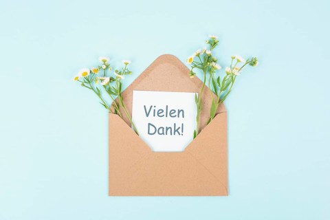 Thank you card, german language, envelope surrounded by spring flowers, being thankful, support,