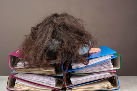 Exhausted tired woman sleeping on a pile of file folders, burnout, stress and overworked, pressure