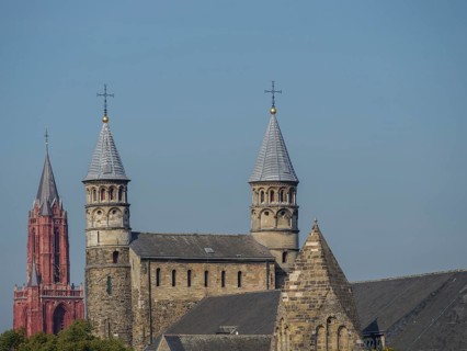 Two historic towers and buildings, shining in the calm daylight, Maastricht, limburg, the