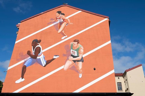 Runner on tartan track, painted house wall, Änggarden neighbourhood, Majorna-Linné district,