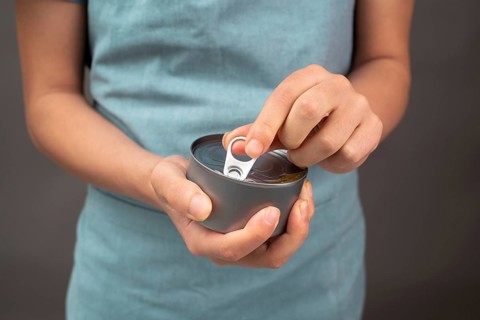 Opening a tin can with preserved food, box with tuna fish, processed ingredients, feeding a pet