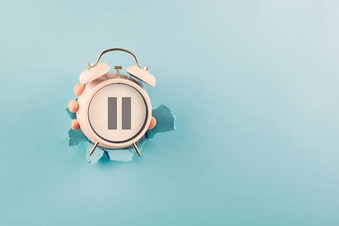 Alarm clock with pause sign, take a break, menopause concept, hormone replacement therapy