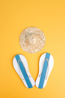 Summer vacation by the sea, flip flops and a straw hat, travel and tourism concept