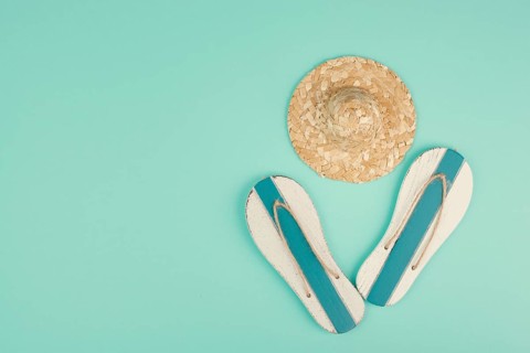 Summer vacation by the sea, flip flops and a straw hat, travel and tourism concept
