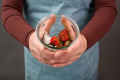 Moldy strawberry fruits with spot fungus in a jar, rotten strawberries, decomposition of the food