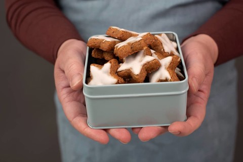 Cinnamon stars, Zimtsterne traditional german christmas cookies in a box, gingerbread with anise