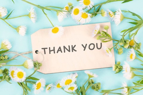 Thank you card surrounded by flowers, being thankful, support, help and charity concept, positive