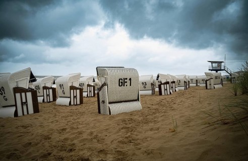 Roofed wicker beach chairs at the baltic sea beach, coast at the island of Usedom in Germany, storm