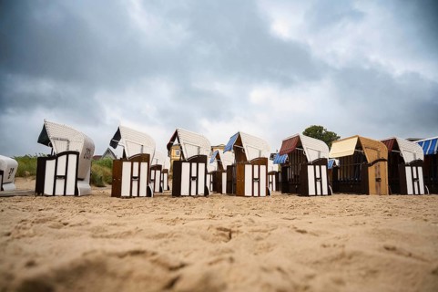Roofed wicker beach chairs at the baltic sea beach, coast at the island of Usedom in Germany, storm