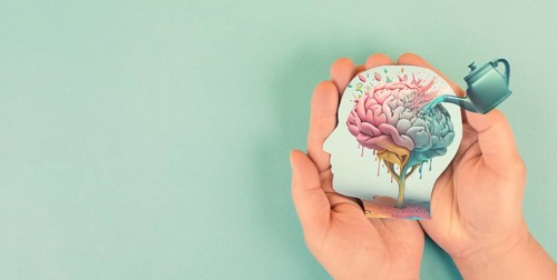 Human brain growing from a flower, watering can is pouring water on the mind, mental health
