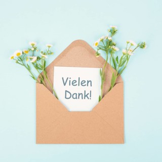Thank you card in an envelope surrounded by flowers, being thankful, support, help and charity